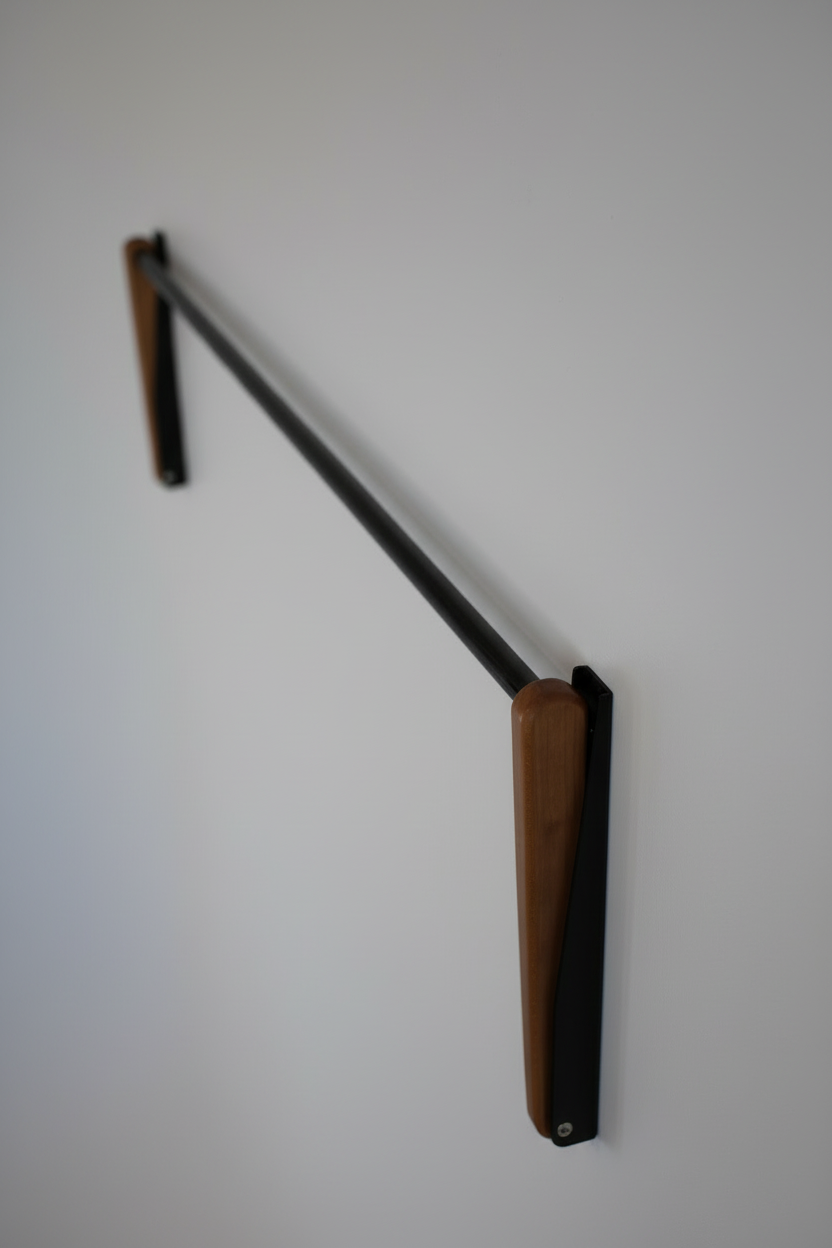 FOLD.ONE wall-mounted clothing rack folded flat against the wall, saving space when not in use