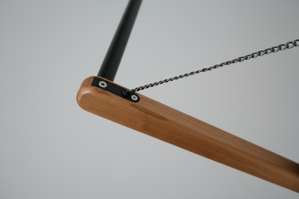 Detail of lacquered cherry wood lever on FOLD.ONE rack in studio setting