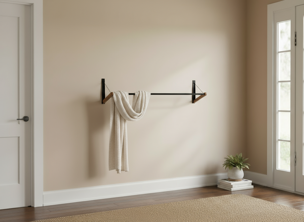 FOLD.ONE wall-mounted foldable clothing rack in an entryway with a scarf hanging on it